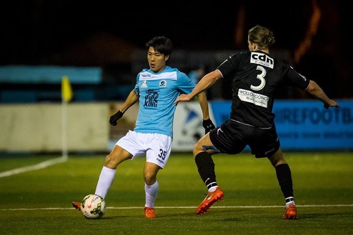 Tomohiro Kajiyama on the ball against an opponent